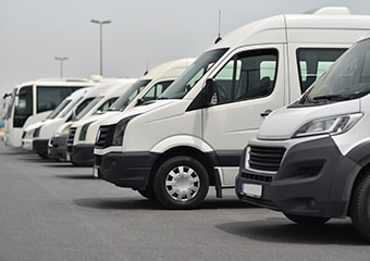 plain white buses parked in a lot