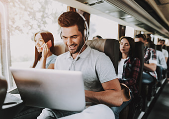 A bus passenger uses a laptop