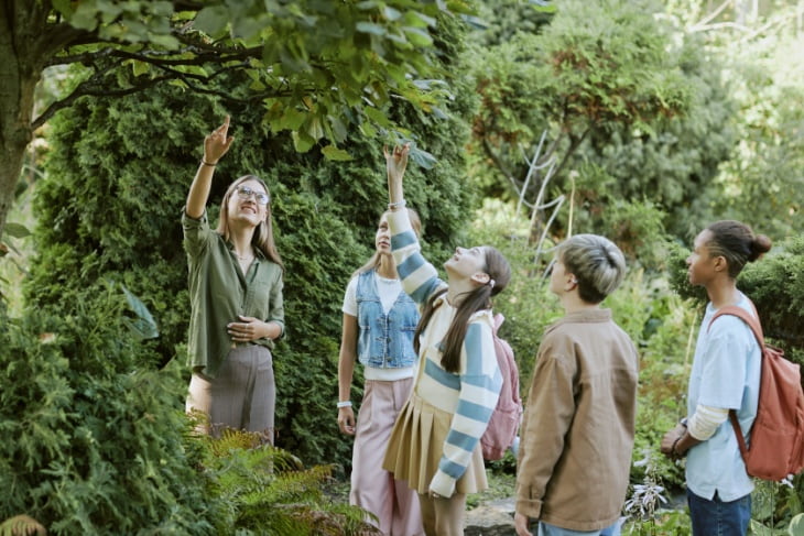 a group of students stand together in nature on a field trip